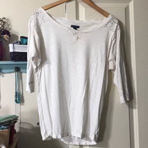 Off-white top, slightly off the shoulder.